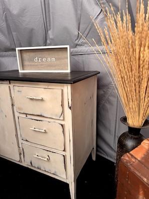 A vintage-style dresser with a sign reading 'dream' on top, a vase with dried reeds, and a grey fabric backdrop. - Tranquil Dome on the Calm Prairies of Alberta, Canada, near Medicine Hat and Redcliff (Redcliff)