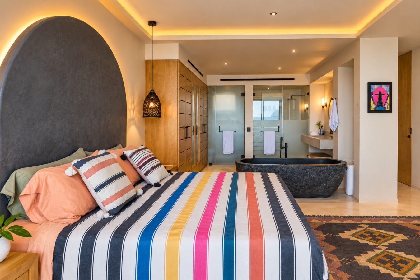 Warm lighting, colorful textiles, and a king bed create an inviting spot to settle in after a day exploring.