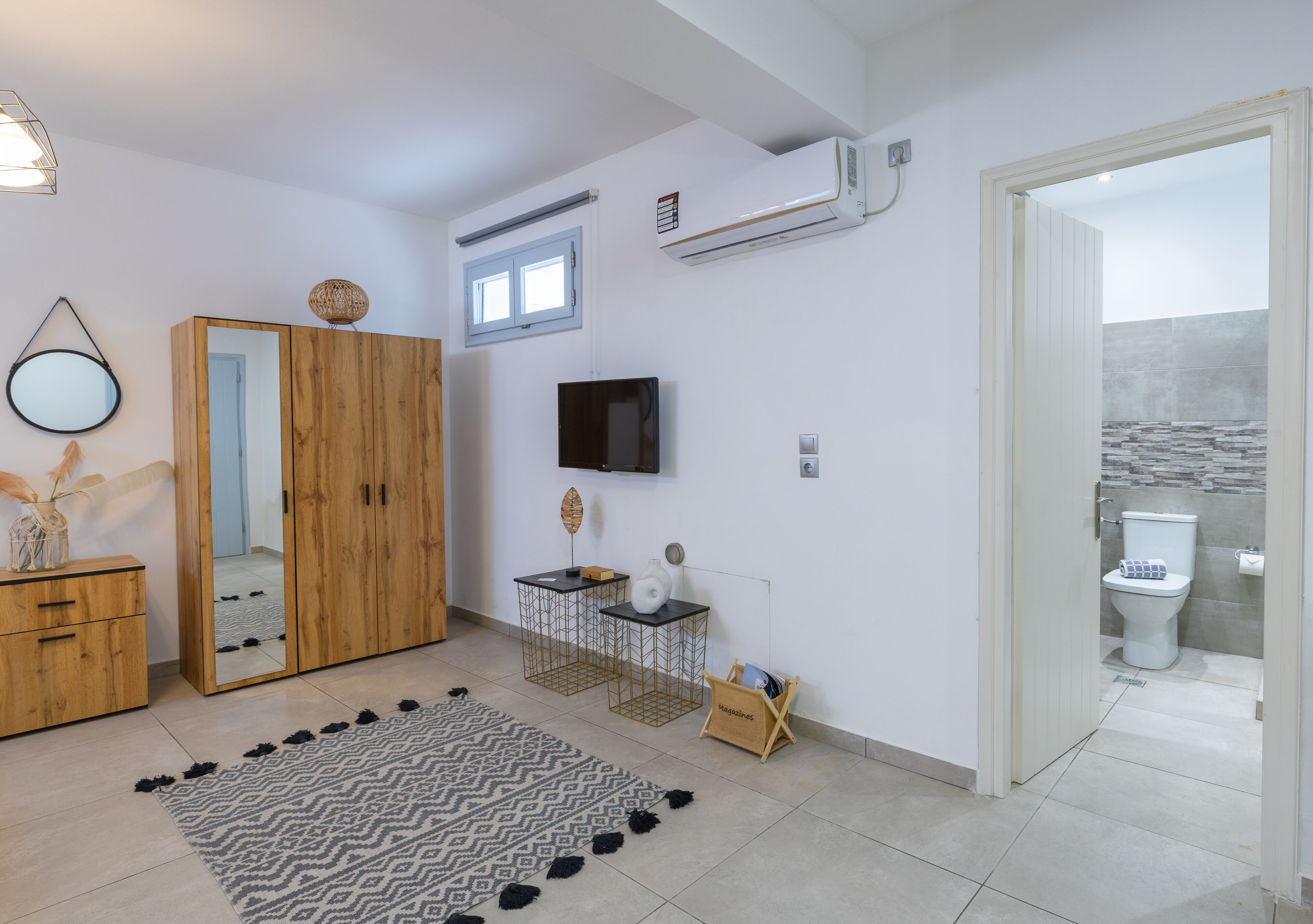 A bathroom with a toilet, a shower area, and a sink.