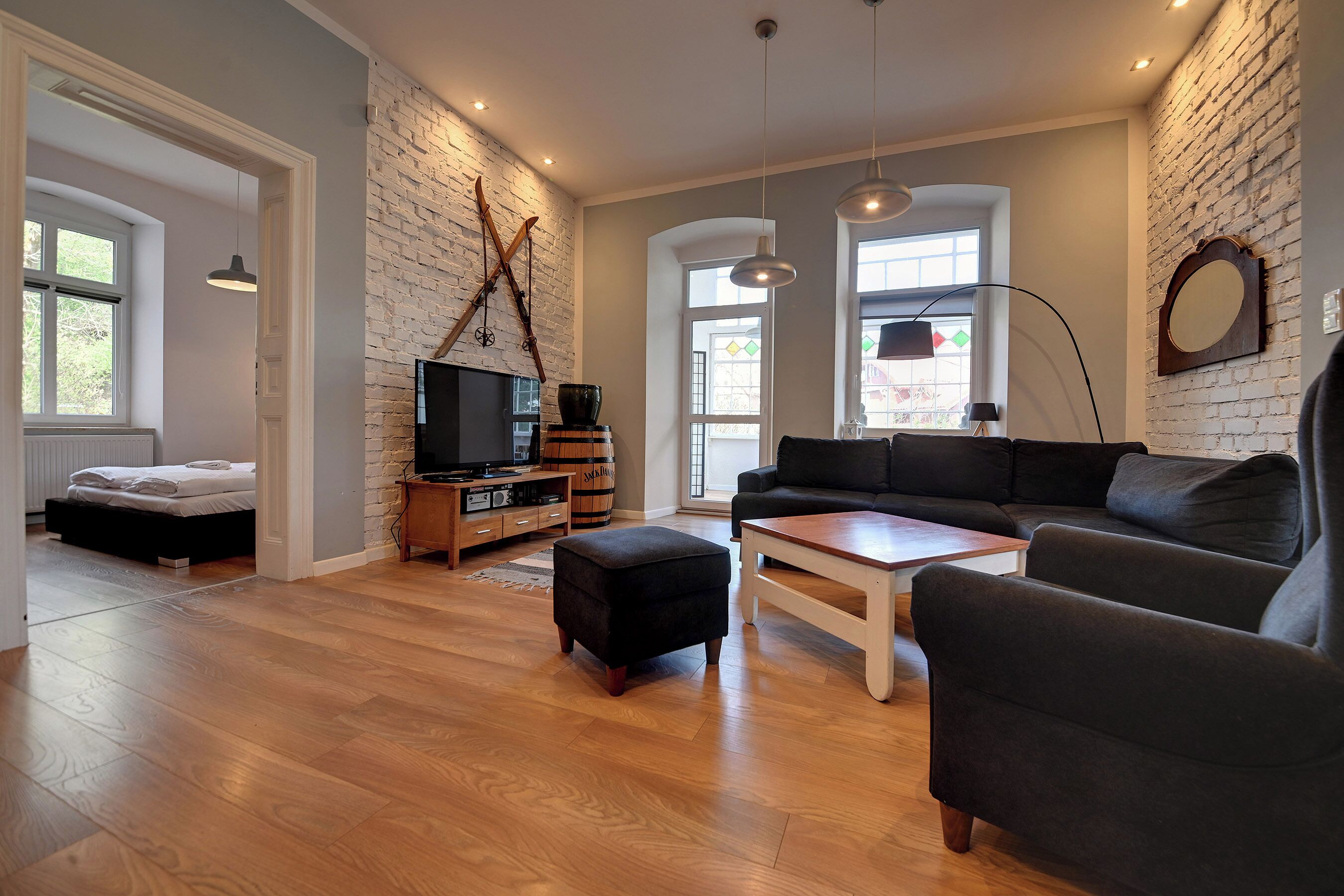 A modern living room with a fireplace, a sofa, a coffee table, and a TV.