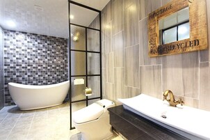 Separate tub and shower, hair dryer, slippers, towels