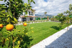 A modern house with a well-maintained lawn and a gravel path.