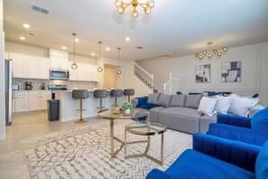 A modern kitchen with white cabinets, a built-in oven, and a microwave. - New Home w/ Exclusive Décor, Private Pool, BBQ & Windsor Cay Resort Access! (Clermont)