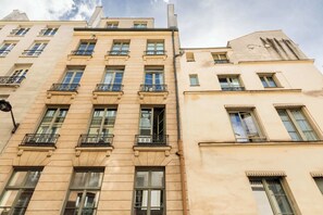 A multi-story building with balconies, large windows, and a classic architectural style. - Cozy Bright Studio for 2 Saint Germain des Pres (Paris)