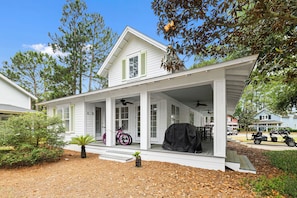 A white house with a covered porch, a bicycle, and a grill. - NEW to VRBO -HUGE PORCH~Golf Cart, FREE ACTIVITIES~HEATED Pool* & HotTub, Gym (Miramar Beach)