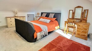 A bedroom with a bed, dresser, and mirror. - Charming Barn Annex With Stables New Forest Escape (Ringwood)