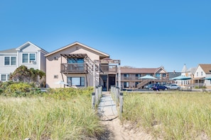 A beachfront hotel with a gated entrance, a pathway leading to the beach, and a view of the ocean. - Steps to Sand! Oceanfront Gem in Old Orchard Beach (Old Orchard Beach)