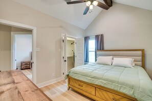 A bedroom with a bed, wooden dresser, and a ceiling fan. - 7 Mi to Afb: Modern 2-unit Combo in San Angelo (San Angelo)