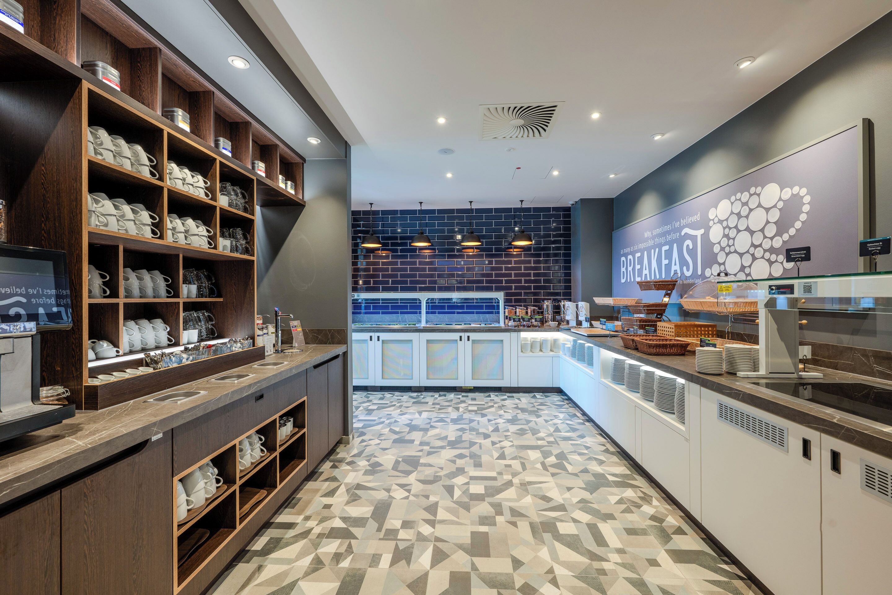 A breakfast area with shelves of mugs and cups, a counter with food items, and a wall with a breakfast sign.