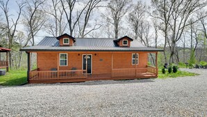 A wooden cabin with a porch, a door, and windows. - 2 Cabins Near Lake Cumberland Boat Ramps! (Somerset)