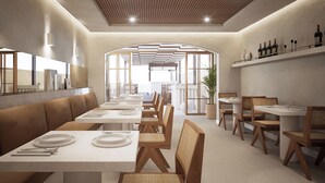 A modern restaurant interior with long communal tables, wooden chairs, and a central archway. - Casa Azure Member Of Meliá Collection (San Lawrenz)