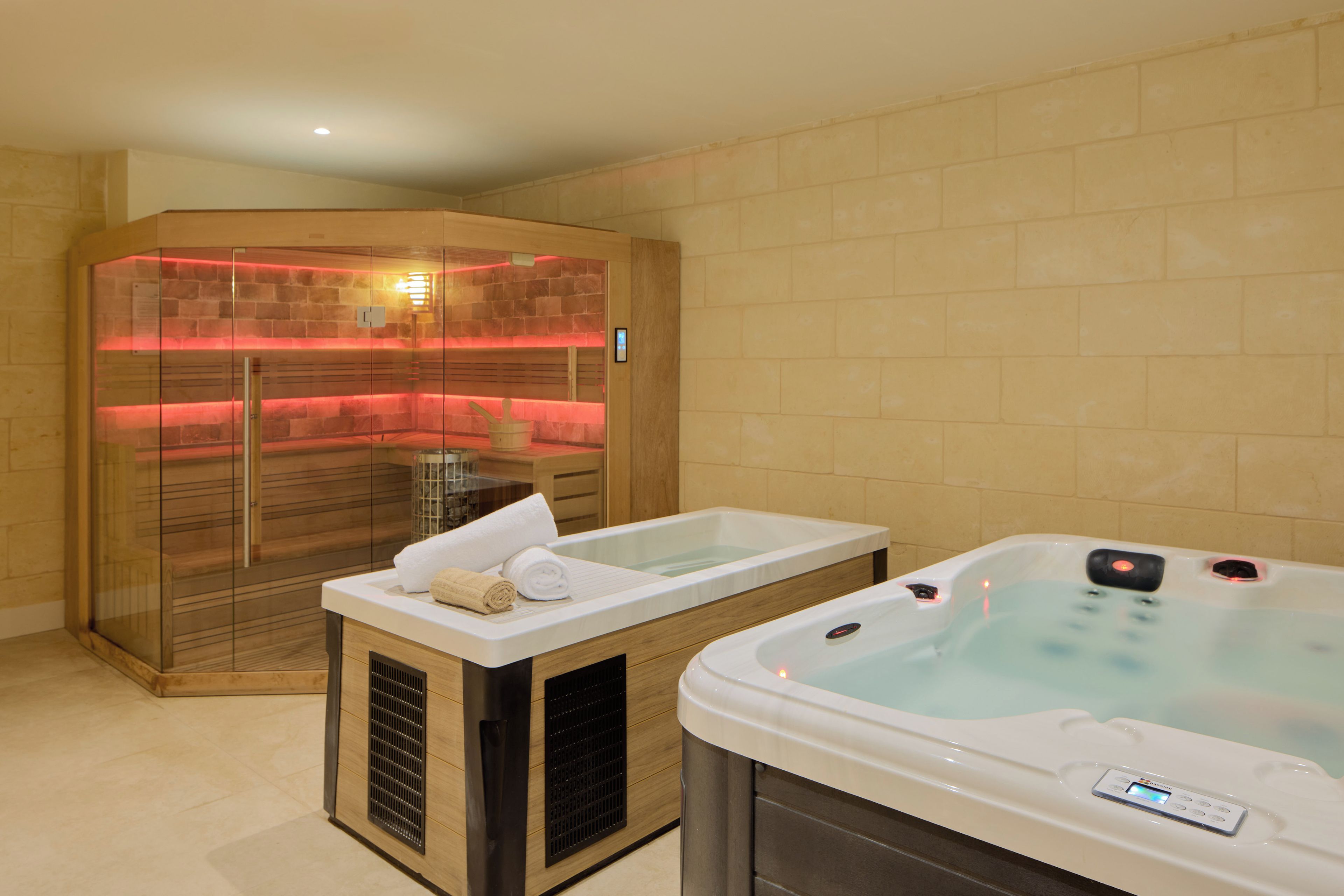 A spa area with two hot tubs and a sauna.