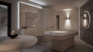 A modern bathroom with a freestanding bathtub, a vanity with a mirror, and a wall-mounted light fixture.