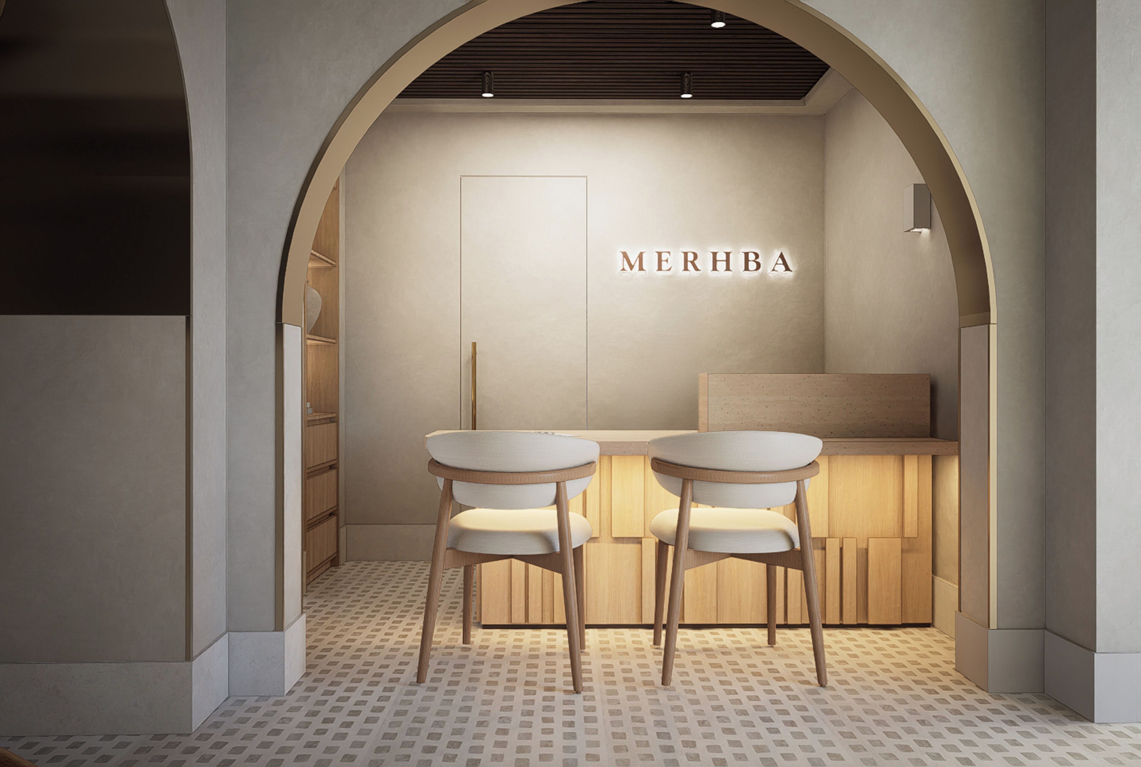 A minimalist interior with two white tables and chairs, a wooden counter, and the name 'MERHBA' on the wall.