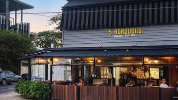 A restaurant named '5 BOROUGHs' with a bar and grill, featuring outdoor seating and a visible bar area.
