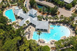 An aerial view of a resort with multiple swimming pools, palm trees, and a covered pavilion. - NatureWalk "Sandy Paws" 3BR + Bunk | Sleeps 10 | Golf Cart | Pets OK | 🐶 (Santa Rosa Beach)