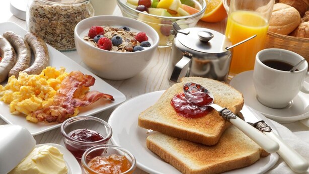 A breakfast setting with various food items and beverages. - The Dome Luxury Hotel (Thasos)