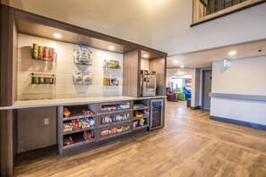 A snack bar with various food items and a popcorn machine. - Ramada Cochrane (Cochrane)