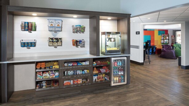 A snack bar with various food items and a popcorn machine. - Ramada Cochrane (Cochrane)