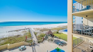 A beachfront hotel with a view of the ocean, a gazebo, and outdoor seating. - Phoenix I 1034 1 Bedroom Condo (Orange Beach)