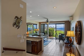 A spacious living area with a kitchen, a dining area, and a view of the outdoors. - Napili Oceanfront 1br Condo Sleeps 4 - Unit B14 1 Bedroom Condo (Lahaina)