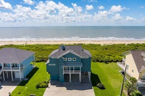 A coastal property with a large house, a smaller house, and a beach view. - Dawn Treader 4 Bedroom Home (Port Bolivar)