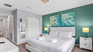 A bedroom with a bed, bedside tables, a mirror, and artwork on the wall. - 4BR Grill Resort Pool Kids Rooms Near Disney 5129 (Kissimmee)