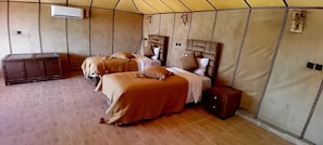 A tent-style room with two beds, a small cabinet, and an air conditioning unit. - Luxury Desert Camp Merzouga - AC, Private Bathroom & Breakfast (Merzouga)