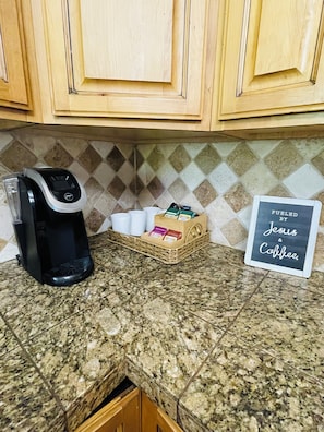 A kitchen with a coffee maker, cups, and a sign stating 'FUELED BY Jesus & Coffee.' - Welcome to the Rosemary and Honeybee cottage in Pocatello, Idaho ! 🌲 (Pocatello)