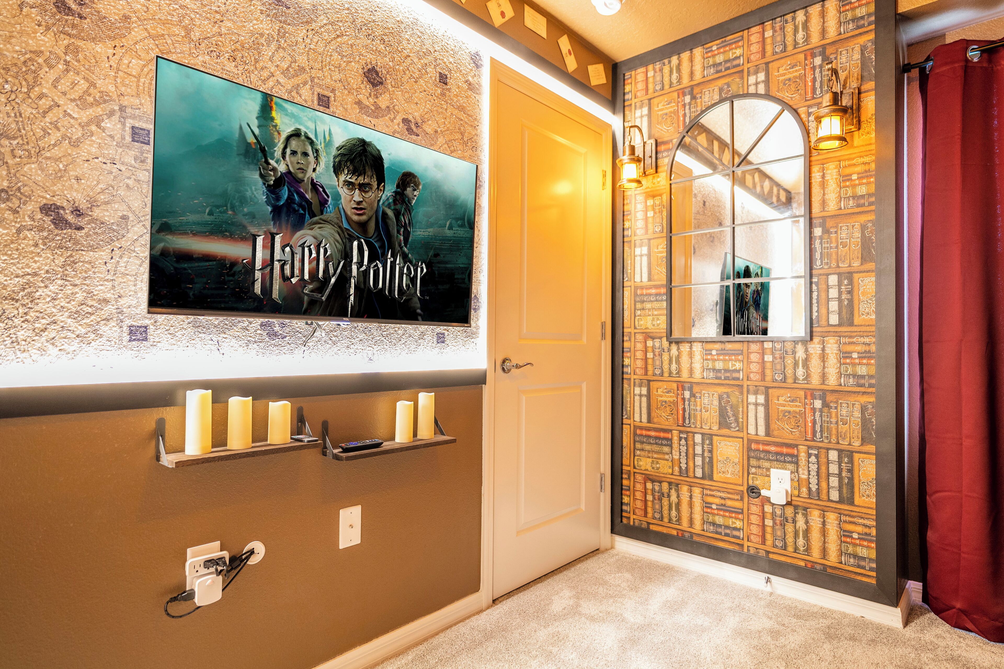 A room with a Harry Potter poster, a bookshelf, and a door with a window.