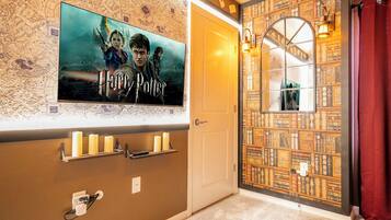 A room with a Harry Potter poster, a bookshelf, and a door with a window.