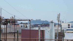 A rooftop with buildings, antennas, and a clear sky. - Peristeri 1 Bd Apt w Balcony and View (Peristeri)