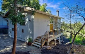 A modern house with a wooden deck and a chimney. - Moonlight Cabin, by @Johnnyswim (Lake Arrowhead)