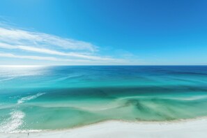 A beach with clear turquoise waters and a sandy shore. - 🦞Gulf Front | Beach Service | Pool | 2BR Ocean Villa 2101🌅 (Panama City Beach)