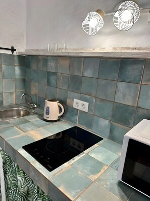 A kitchen with a sink, kettle, stove, and microwave. - Vacation Home 'Casa Veronica 1 Planta Baja' with Wi-Fi (Arona)