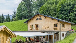 Un chalet en bois doté d’un espace extérieur couvert avec des sièges et d’une enseigne sur laquelle on peut lire : « See & Lime ».
