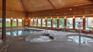 A wooden interior with a pool, hot tubs, and outdoor seating.