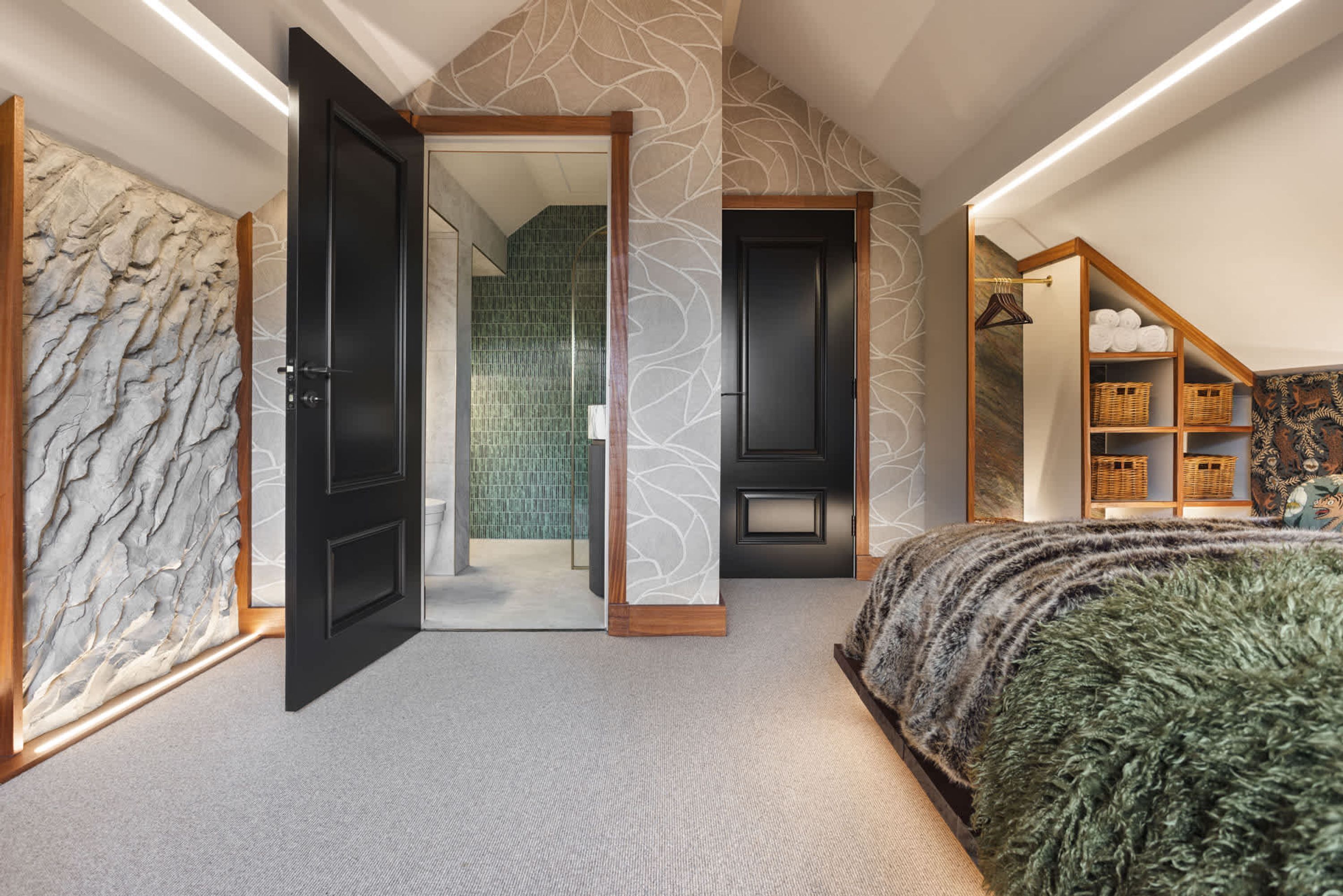 A bedroom with a large bed, a wardrobe, and a walk-in closet.