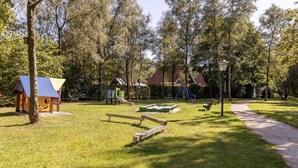 A park with playground equipment, a small wooden structure, and a path. - Holiday Home With Sauna, 18 km. From Tilburg (Diessen)