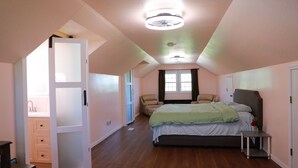 A bedroom with a bed, a chair, a small table, and a window. - Private Country Suite Near Truman Lake & Fishing (Clinton)