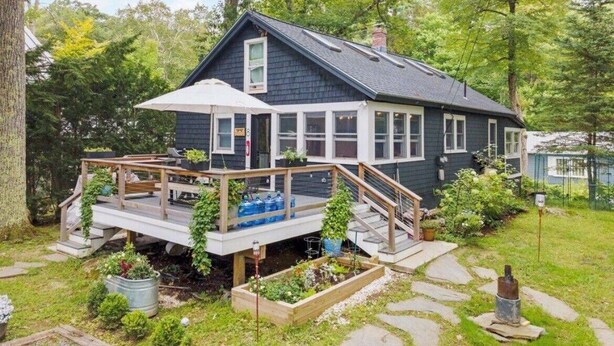A house with a deck, a covered porch, and a garden. - Sunapee Shore and Summit (Newbury)