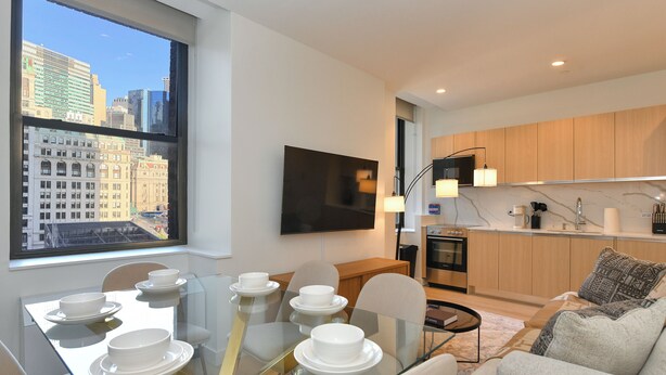 A modern apartment with a dining area, kitchen, and living room. - Urban Escape : Bright 2BR/2BA in FiDi (New York)