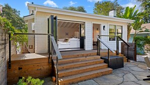 A modern house with a wooden deck, a staircase, and a white interior. - Humphrey House | Walk to Beach, Coast Village Rd, 3 En Suite Bedrooms (Montecito)