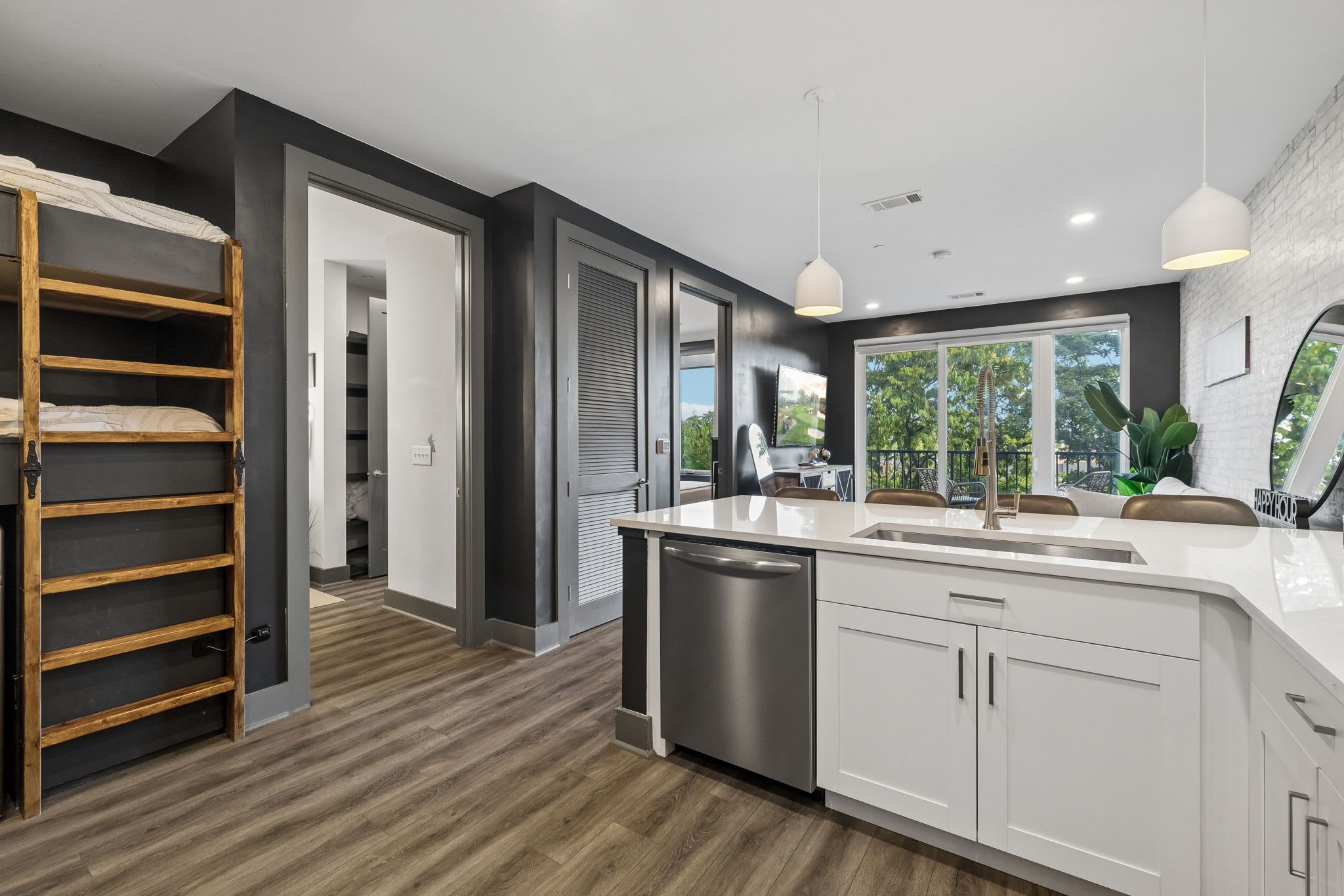 A modern kitchen with a central island, stainless steel appliances, and a view to the outdoors.