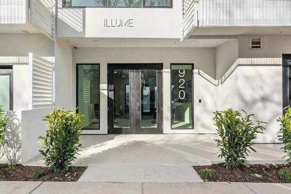 A modern building with the name 'ILLUME' and the number '920' on the facade. - Skyline-View Condo with WiFi, Central AC, WD, Balcony, Seasonal Pool, & Gym (Nashville)