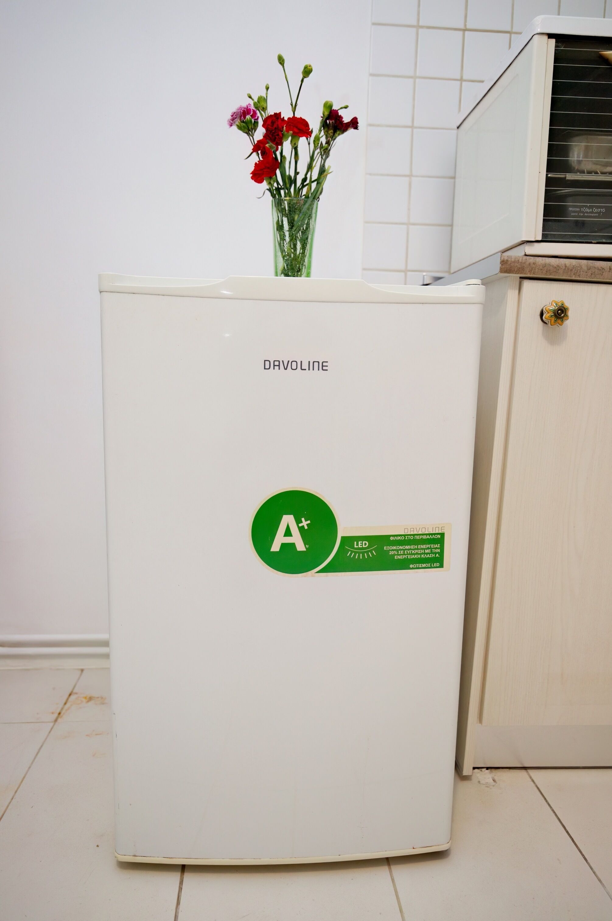 A white refrigerator with a sticker indicating an A+ energy efficiency rating.