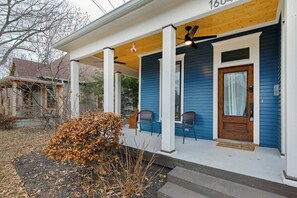 A house with a porch, a wooden door, and a number '1604' on the wall. - 1920s Dog  Welcome Escape N East Nashville, Firepit (Nashville)
