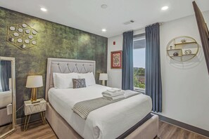 A hotel room with a large bed, two bedside tables, a wall-mounted shelf, and a window with curtains. - Rockstar Downtown Condo Escape & Private Balcony (Nashville)