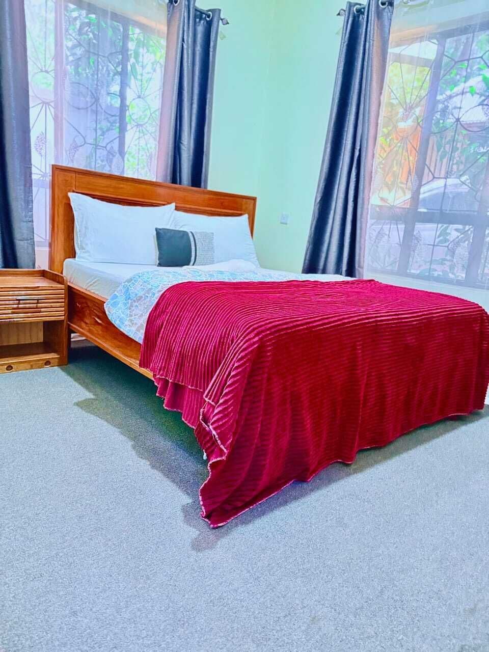 Bungalow familiar, vista al jardín | Espacio para trabajar con laptop y cortinas blackout 