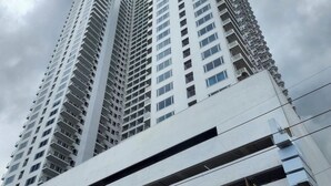 A high-rise building with multiple floors, large windows, and a modern architectural design. - Dyad Suites Pasay (Pasay)